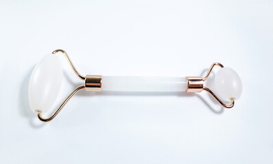 White massage quartz roller for the face close-up isolated on a white background. Beauty and care...