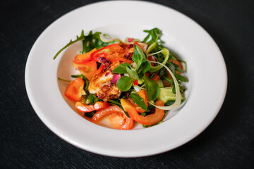 Vegetable salad with grilled cheese. Vegetarian dish.