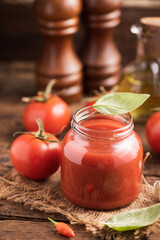 Jar of home made classic Tomato sauce on wooden table