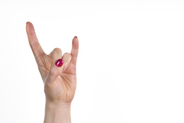   a woman's hand with a pink nail polish on it, making a peace sign with her fingers
