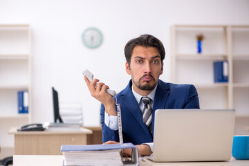 Young male employee working in the office