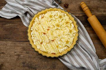 Step 1. Before baking. Homemade open apple pie. Tart with cottage cheese and stars. Pie for July 4th. Patriotic food for Independence Day. Wooden background. Top view.