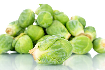 Organic ripe brussels sprouts, close-up, isolated on white.