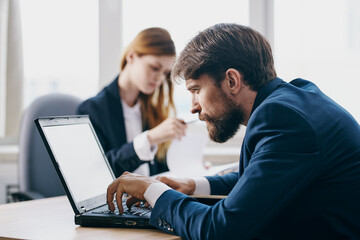 business man and woman sitting in front of a laptop teamwork internet technologies