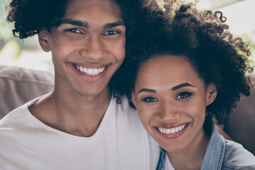 Photo of positive afro american young people friends sit couch enjoy weekend rest indoors inside house home