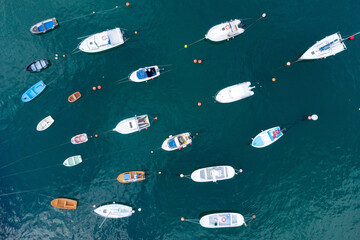 Fototapeta premium Aerial top down view of yachts and boats moored at a marina. High quality photo. 