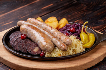 Traditional german fried meat with boiled potatoes, red cabbage and vegetables