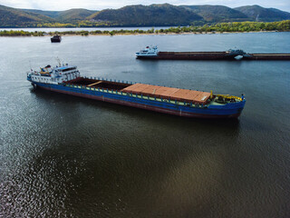 Aerial view of unloaded dry cargo ships on river.