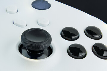 Next generation white game controller isolated on black background. Macro close up