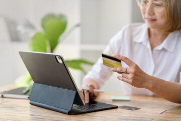 Businesswoman enjoy shopping online using tablet computer and credit card at office