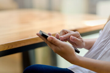 Close up. Woman hand using smartphone order goods online.