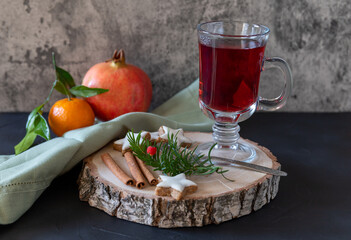 Mulled wine with spices and cinnamon stars on the wooden background