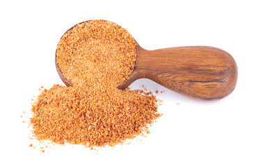 Coconut sugar isolated on white background. Brown unrefined coconut palm sugar in wooden spoon.