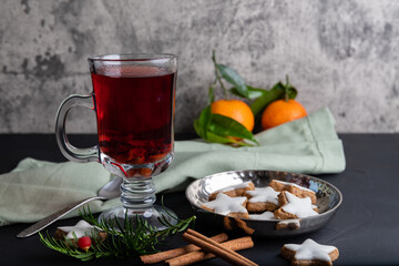 Mulled wine with spices and cinnamon stars on the dark background