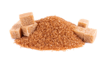 Brown sugar isolated on white background. Heap of cane sugar crystals and sugar cubes.