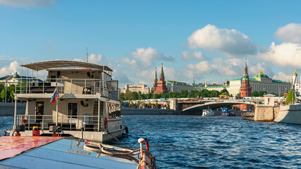 view from a tourist ship on the Moskva River and the towers of the Moscow Kremlin against the...
