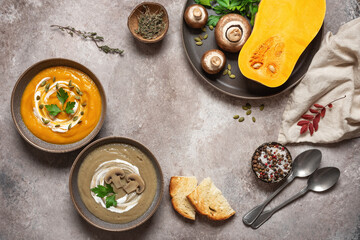 Pumpkin and mushroom cream soup in a bowl on a brown rustic background. Vegan or vegetarian lunch. Warm winter soup. Top view, flat lay.