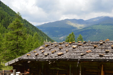 A roof of an alpine hut and mountains behind in Southtyrol 