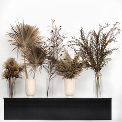 decorative bouquet of dried flowers in a black vase with reeds on a white background