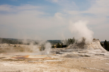 trees, river, Geyser and hot spring in old faithful basin in Yellowstone National Park in Wyoming