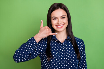 Photo of responsible girl ask call back fingers phone gesture wear dotted blouse isolated on green...