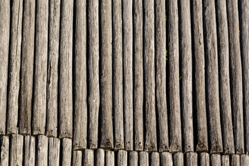 Wooden logs fence background, palisade stockade in a castle