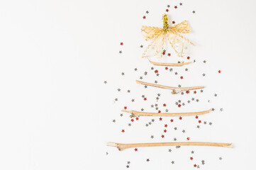 christmas tree made of sticks and decorations on a white background.Flat lay,christmas card,top view