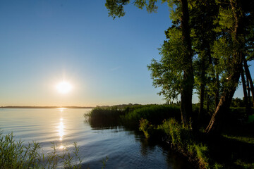 Obraz na płótnie Canvas Zachód słonca na mazurach, słońce nad jeziorem, Mazurskie jeziora, Mazurskie jezioro, Szuwary, Jeziora, Woda