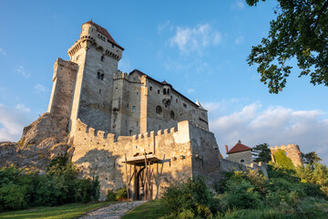 Fototapeta premium Medieval castle Liechtenstein Burg in warm sunset colors, located in Vienna woods near small town Maria Enzersdorf, Lower Austria