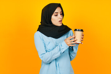 Muslim a glass of coffee in hands near the face isolated background