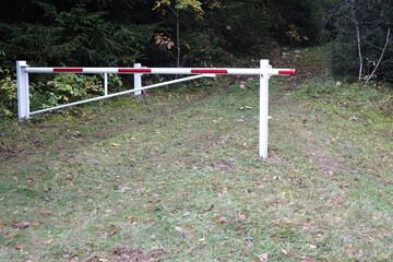 Closed red and white barrier gate in a German water protection habitat, Züsch, Neuhütten, Rhineland Palantinate, Germany
