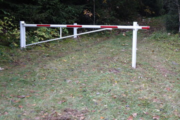 Closed red and white barrier gate in a German water protection habitat, Züsch, Neuhütten, Rhineland Palantinate, Germany
