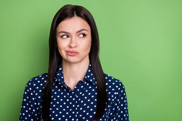 Photo of nice unsure straight hairdo young working lady look empty space wear blue shirt isolated on green color background