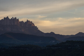 Views of a strange mountain at sunset, with cloudy skies.