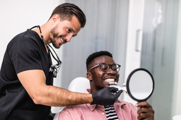 African American man having dental treatment at dentist's office.