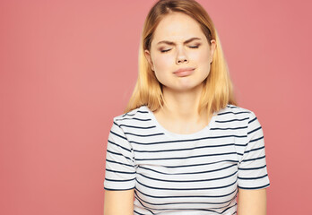 blonde woman in a striped T-shirt discontent upset studio emotions