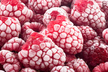 Frozen raspberries covered with hoarfrost, fresh summer berries. Raspberries as background.