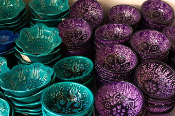 Details of Georgia: national patterns on ceramic dishes. Multicolored bowls with patterns 