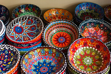 Details of Georgia: national patterns on ceramic dishes. Multicolored bowls with patterns 