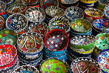 Fototapeta na wymiar Details of Georgia: national patterns on ceramic dishes. Multicolored bowls with patterns 