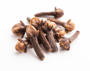 Dry cloves on white background. Pile of spice cloves macro close-up.