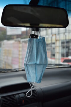 Protective Face Mask On The Car Rearview Mirror