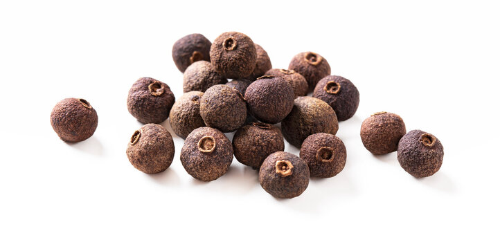 Pile of allspice pepper isolated on white. Jamaica pepper, pimento spice, allspice peppercorns or myrtle pepper. Macro. Clipping path.
