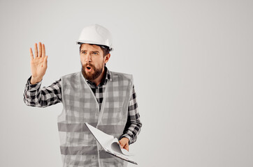 male worker in a white helmet blueprints Professional isolated background