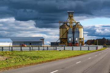 modern granary elevator and seed cleaning line in silver silos on agro-processing and manufacturing plant for storage and processing drying cleaning of agricultural products, flour, cereals and grain