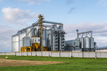 Obraz premium modern granary elevator and seed cleaning line in silver silos on agro-processing and manufacturing plant for storage and processing drying cleaning of agricultural products, flour, cereals and grain