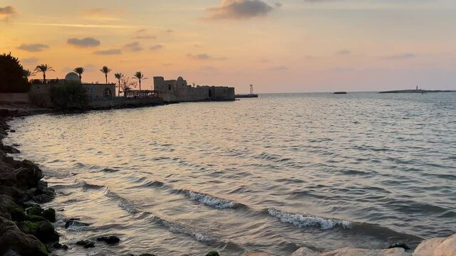The city of Sidon in Lebanon. Sidon Sea Castle, built by the crusaders - Saida corniche and building. Sidon sea at sunset