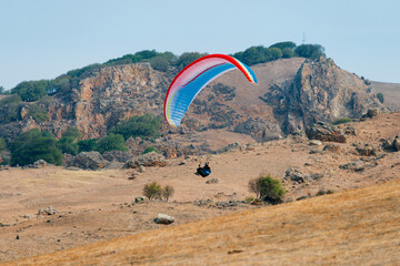Paraglider Pilot Flying in the Sky - 467008789