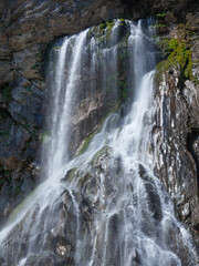 Obraz premium Waterfall on gray green stone rock texture background