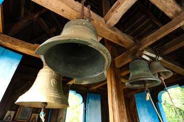 Fototapeta premium Old church bell and prefabricated structure. Close up of old metal, cracked, orthodox church bells. Selective focus. The concept of Orthodoxy.